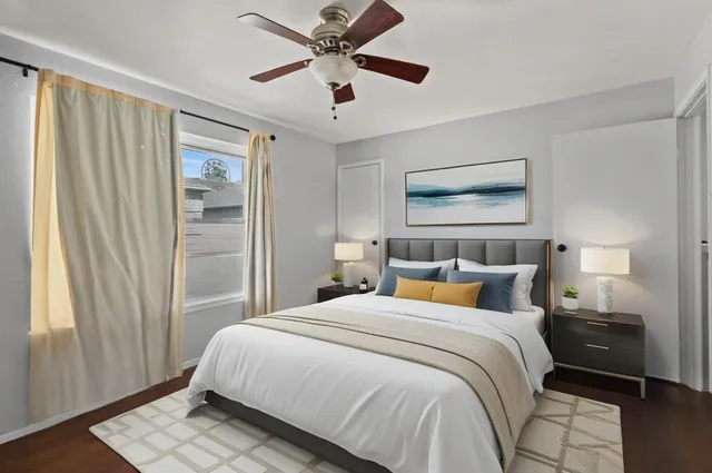 a bedroom with a large bed and a window