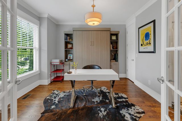 a bed sitting in a bedroom next to a window