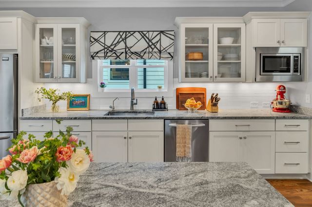 a kitchen with a sink cabinets and window