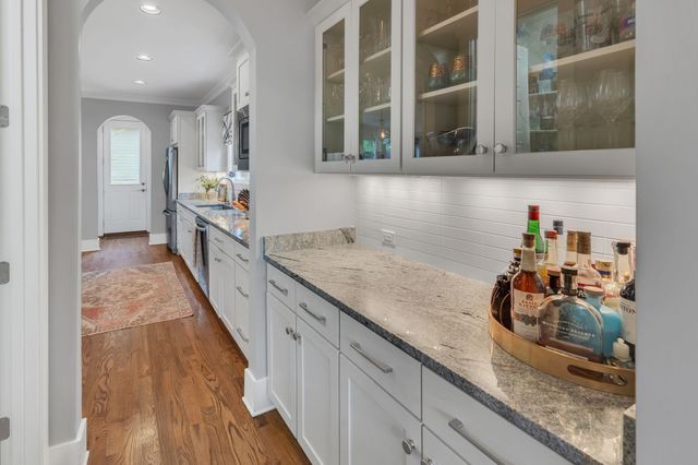 a hallway with sink and mirror