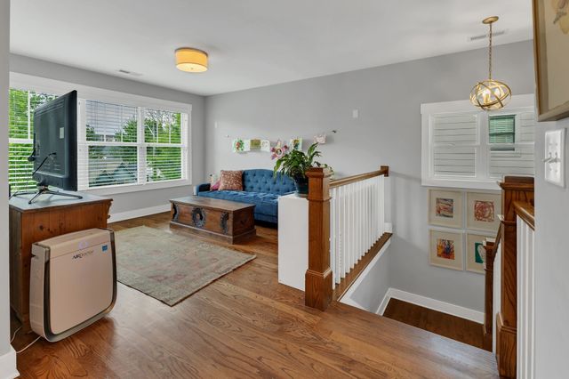 a very nice looking room with wooden floor and a window