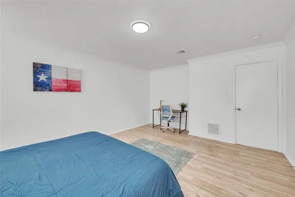 a bed room with a bed and a chair