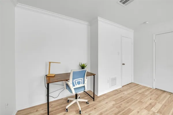 a workspace with furniture and a wooden floor