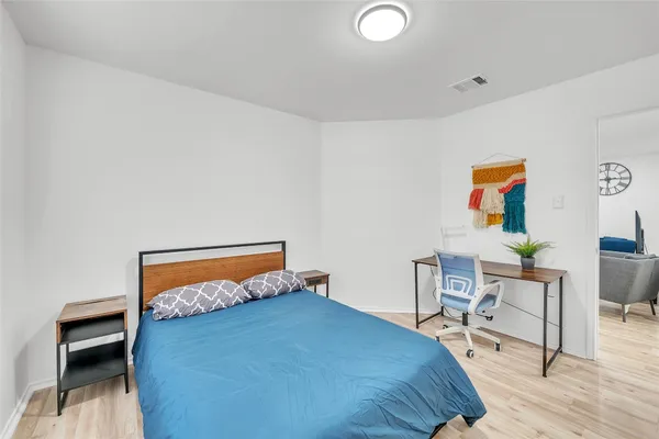 a bedroom with a bed and a desk
