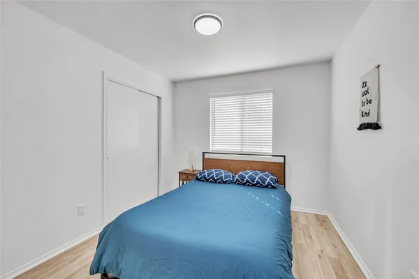 a bedroom with a bed and window