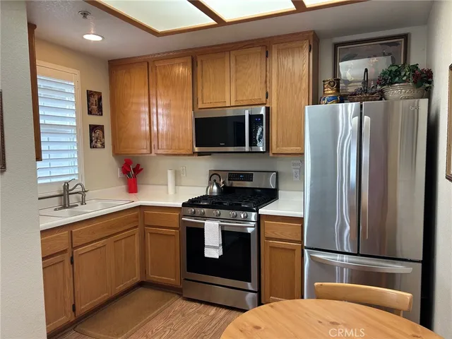 a kitchen with a sink stove and refrigerator