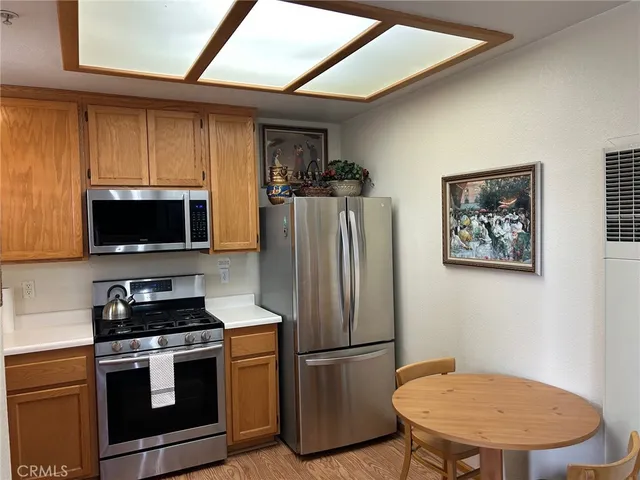 a kitchen with stainless steel appliances a refrigerator stove and microwave