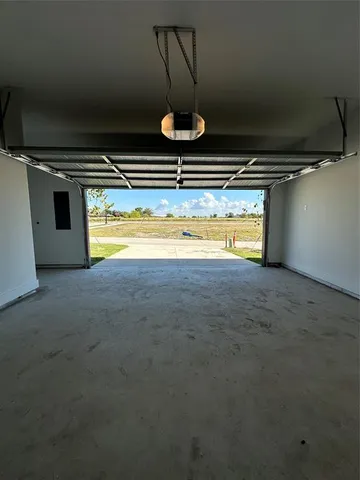 a view of a room with water heater and wooden cabinets