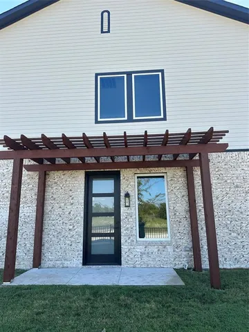 a view of backyard with deck and outdoor kitchen