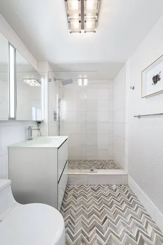 a cabinet with a view of kitchen and a wooden floor