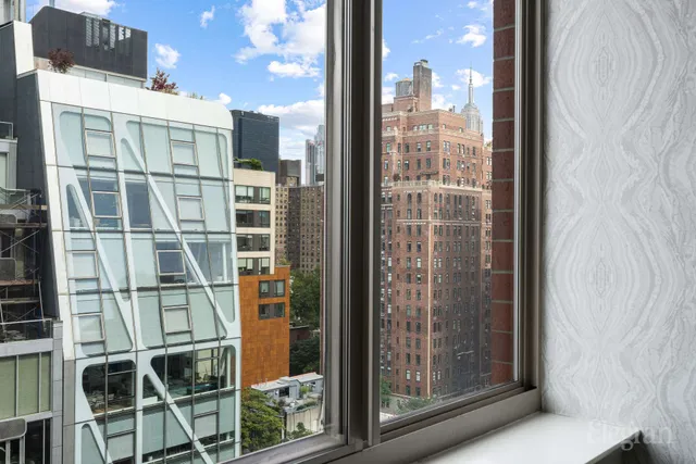a living room filled with furniture and a floor to ceiling window
