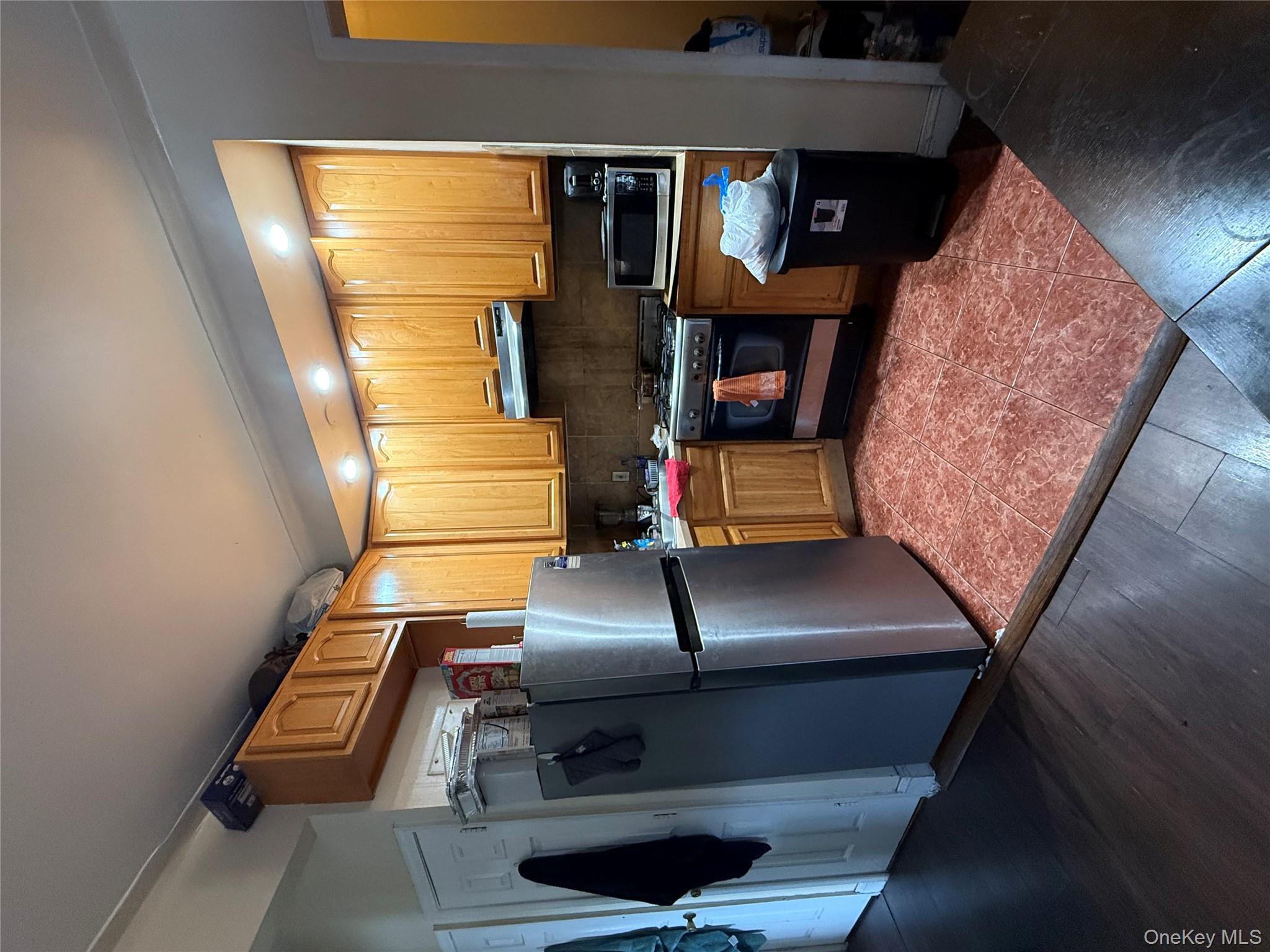 2913 Foster Avenue, Unit 6F Brooklyn, NY 11210 - Photo 2 of 5 a kitchen with granite countertop a refrigerator stove and sink