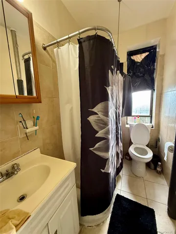 a bathroom with a sink a toilet a mirror and shower