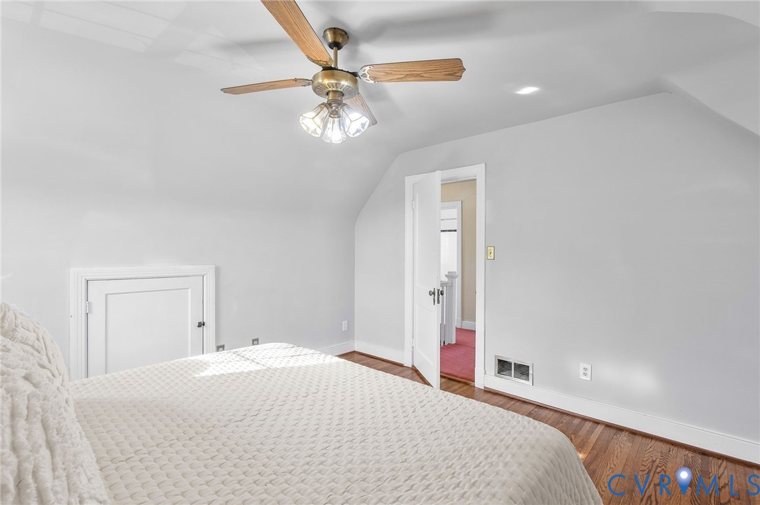 6100 Club Road Henrico, VA 23228 - Photo 21 of 30 a bedroom with a large bed and a chandelier