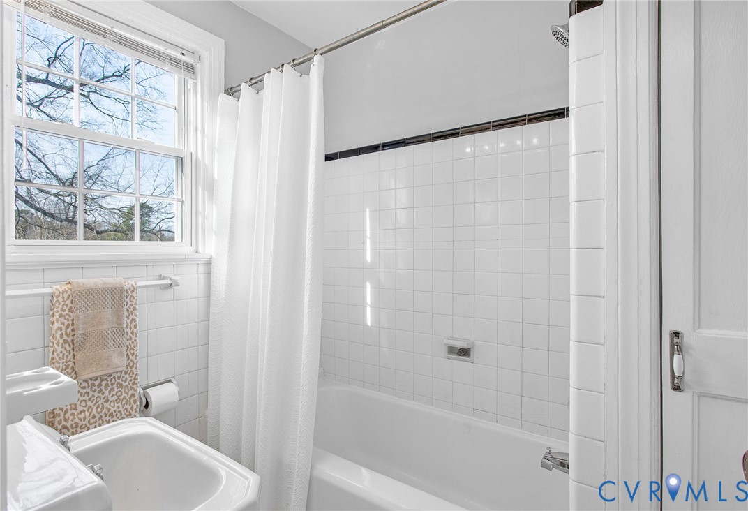 6100 Club Road Henrico, VA 23228 - Photo 23 of 30 a bathroom with a shower curtain and a sink
