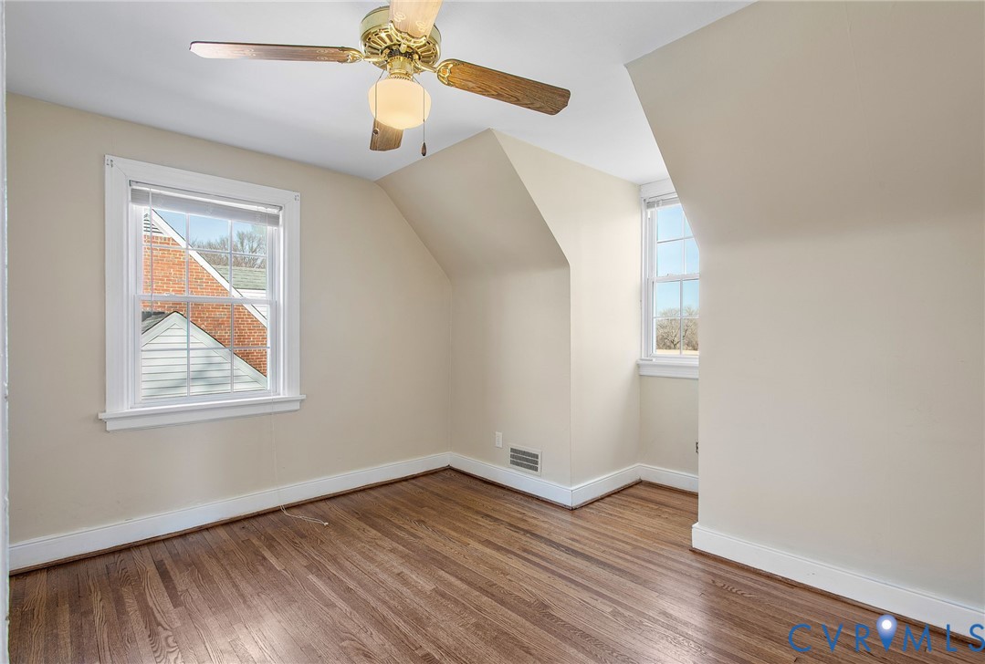 6100 Club Road Henrico, VA 23228 - Photo 24 of 30 an empty room with wooden floor chandelier fan and windows