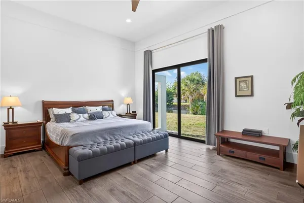 a bedroom with a bed and a large window