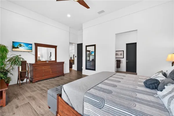 a bedroom with a bed and a television