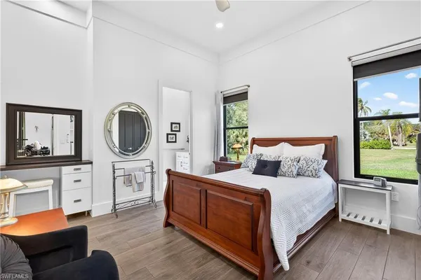 a bedroom with a bed and a large window