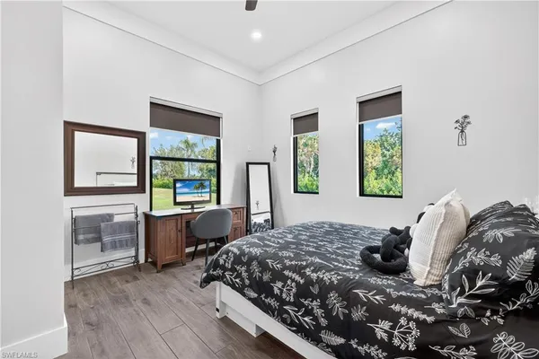 a bedroom with a bed and wooden floor