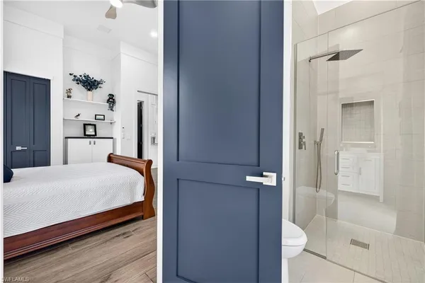 a bathroom with a granite countertop toilet sink and a mirror