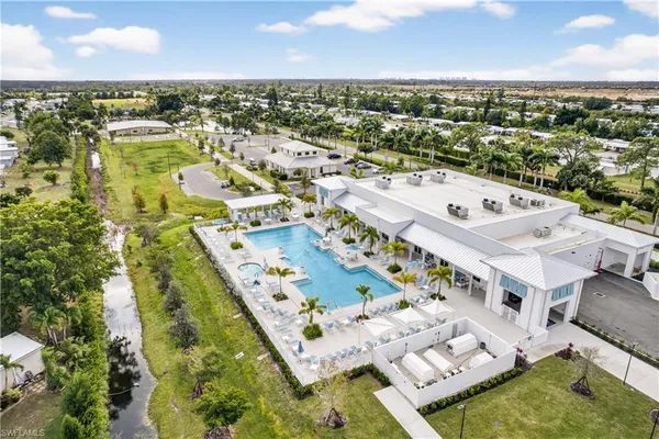 an aerial view of residential houses with outdoor space and lake view