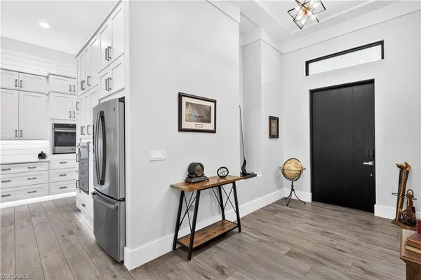 a view of a kitchen with furniture and wooden floor