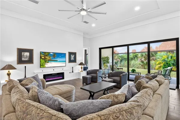 a living room with furniture a large window and a flat screen tv