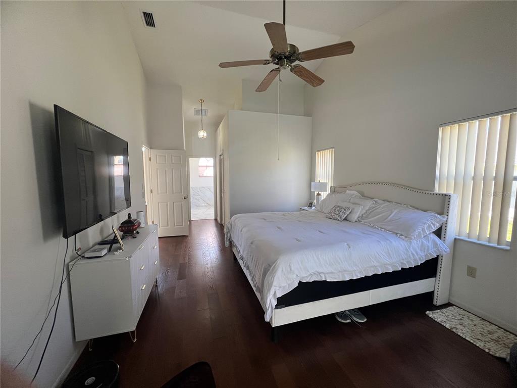 14189 Cornewall Lane Spring Hill, FL 34609 - Photo 18 of 36 a bedroom with a bed and a flat screen tv