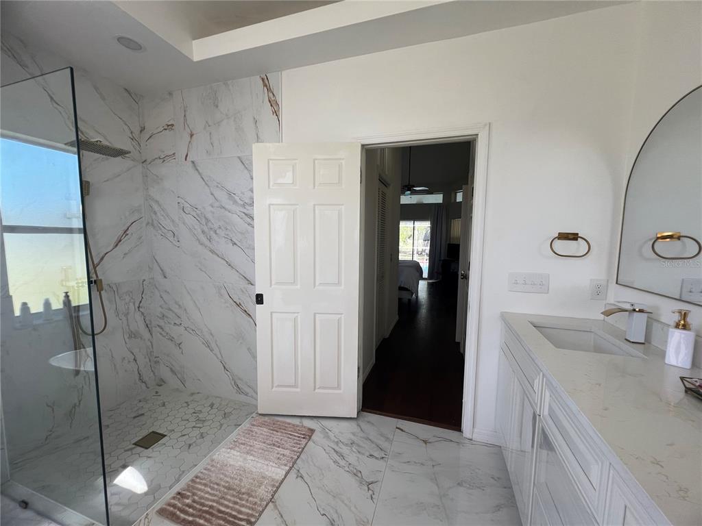 14189 Cornewall Lane Spring Hill, FL 34609 - Photo 20 of 36 a bathroom with a sink and a shower