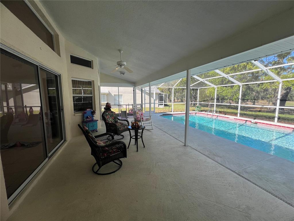 14189 Cornewall Lane Spring Hill, FL 34609 - Photo 30 of 36 a view of a chairs and table in a room