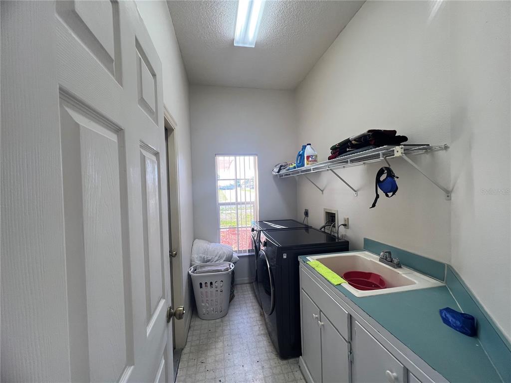 14189 Cornewall Lane Spring Hill, FL 34609 - Photo 35 of 36 a kitchen that has a sink and a stove in it