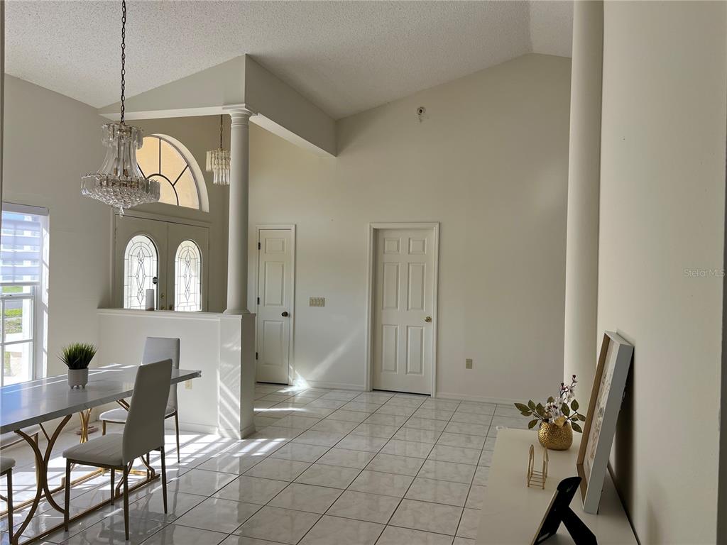 14189 Cornewall Lane Spring Hill, FL 34609 - Photo 5 of 36 a view of hall way with furniture and chandelier