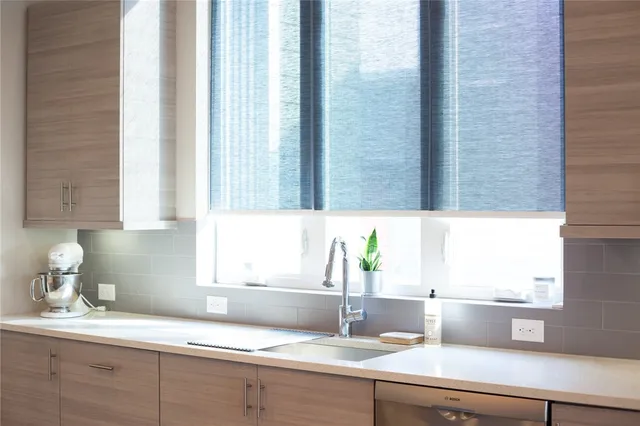 a bathroom with a granite countertop shower and a mirror