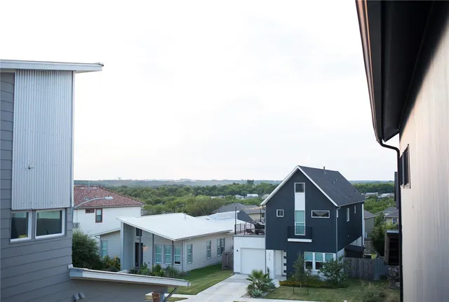 a view of a balcony with a floor to ceiling window and wooden floor