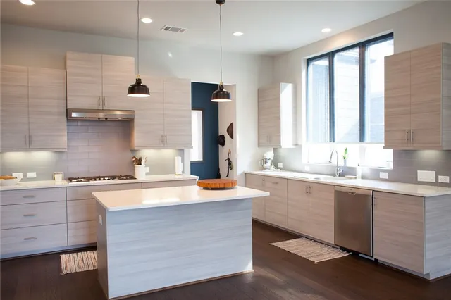 a kitchen with a sink cabinets and a window