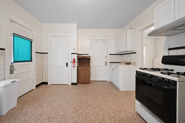 a kitchen with stainless steel appliances a stove a sink and a refrigerator