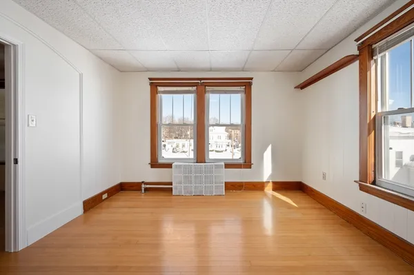 an empty room with windows and closet