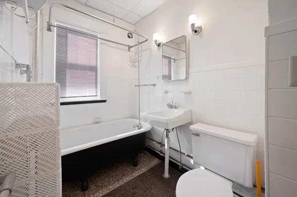 a bathroom with a sink toilet a mirror and shower