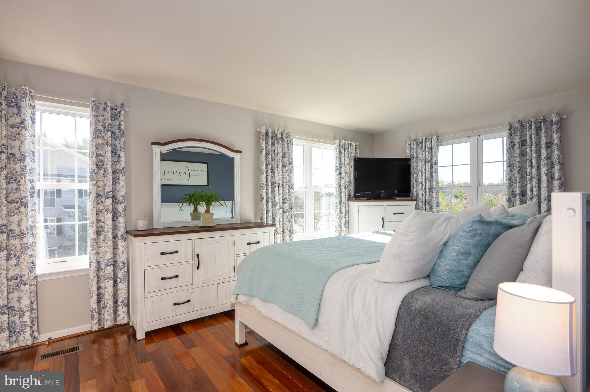 2308 Quilting Bee Road Catonsville, MD 21228 - Photo 17 of 37 a living room with a bed furniture flat screen tv and large window