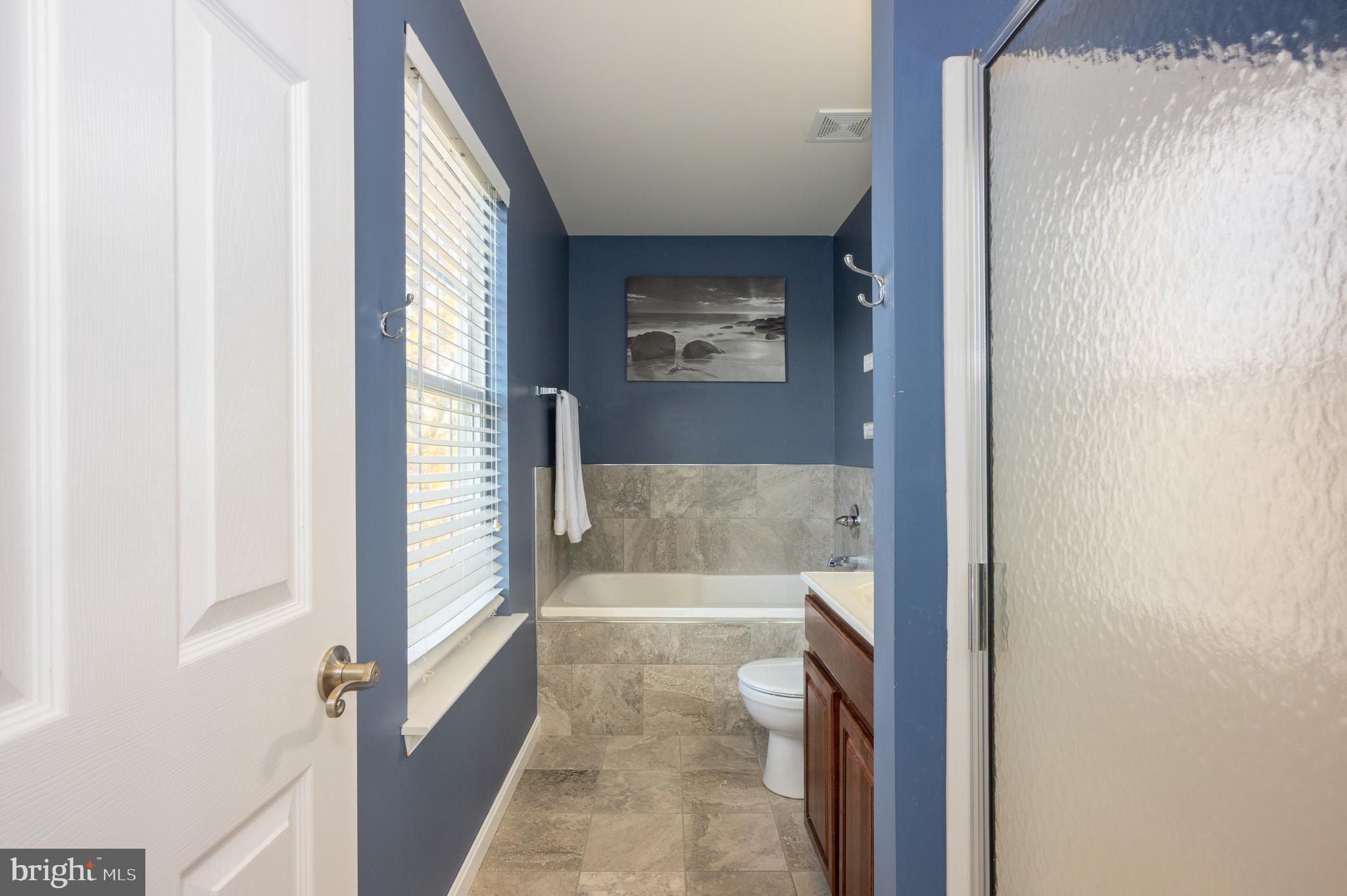 2308 Quilting Bee Road Catonsville, MD 21228 - Photo 20 of 37 a bathroom with a bathtub and a shower