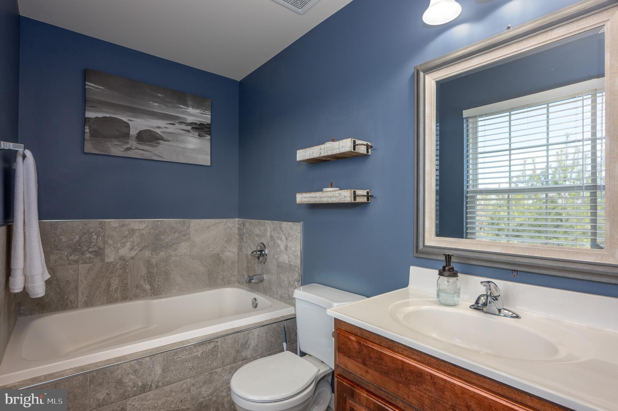 2308 Quilting Bee Road Catonsville, MD 21228 - Photo 21 of 37 a bathroom with a sink a toilet and bathtub