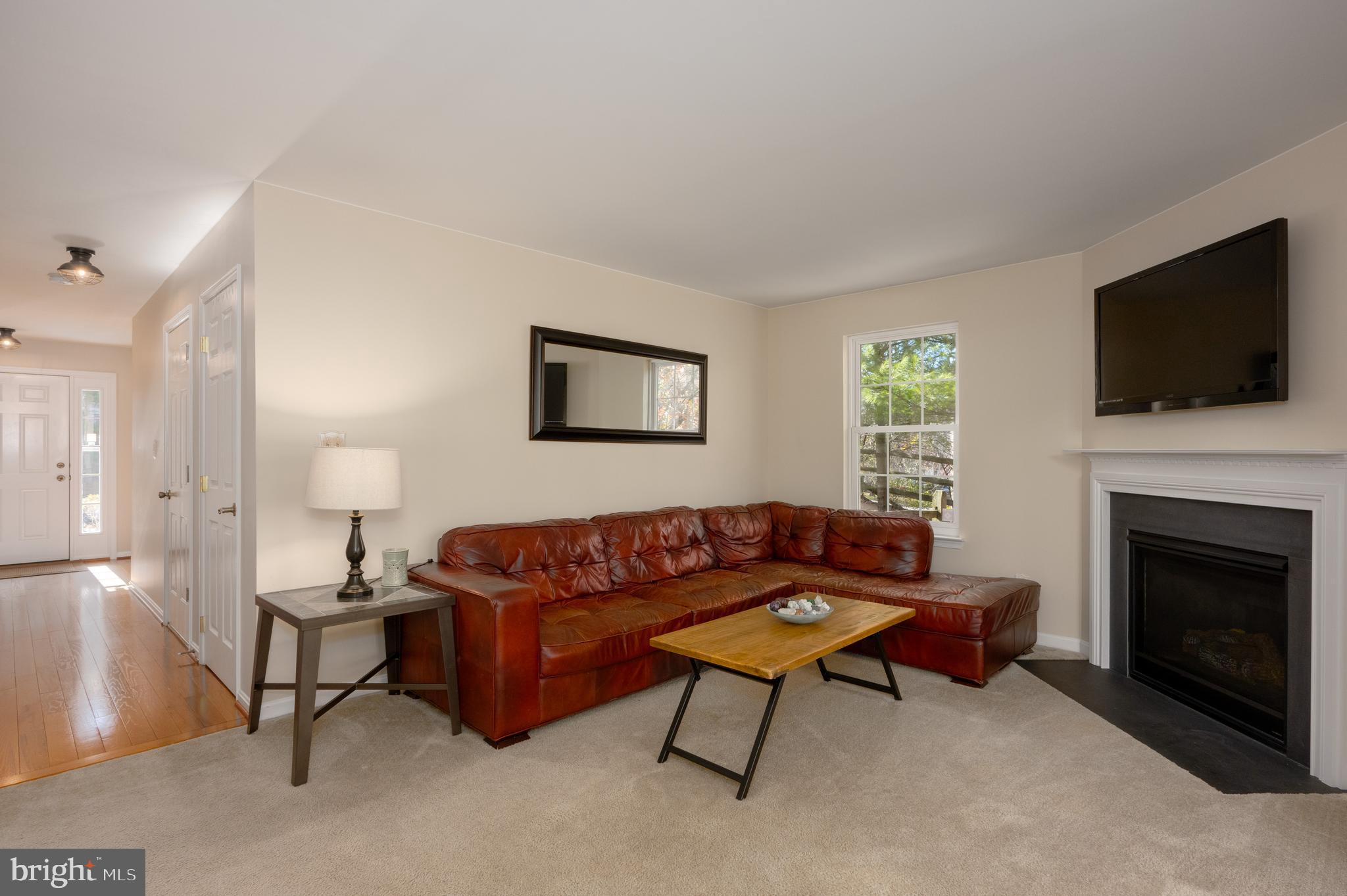 2308 Quilting Bee Road Catonsville, MD 21228 - Photo 22 of 37 a living room with furniture a flat screen tv and a fireplace