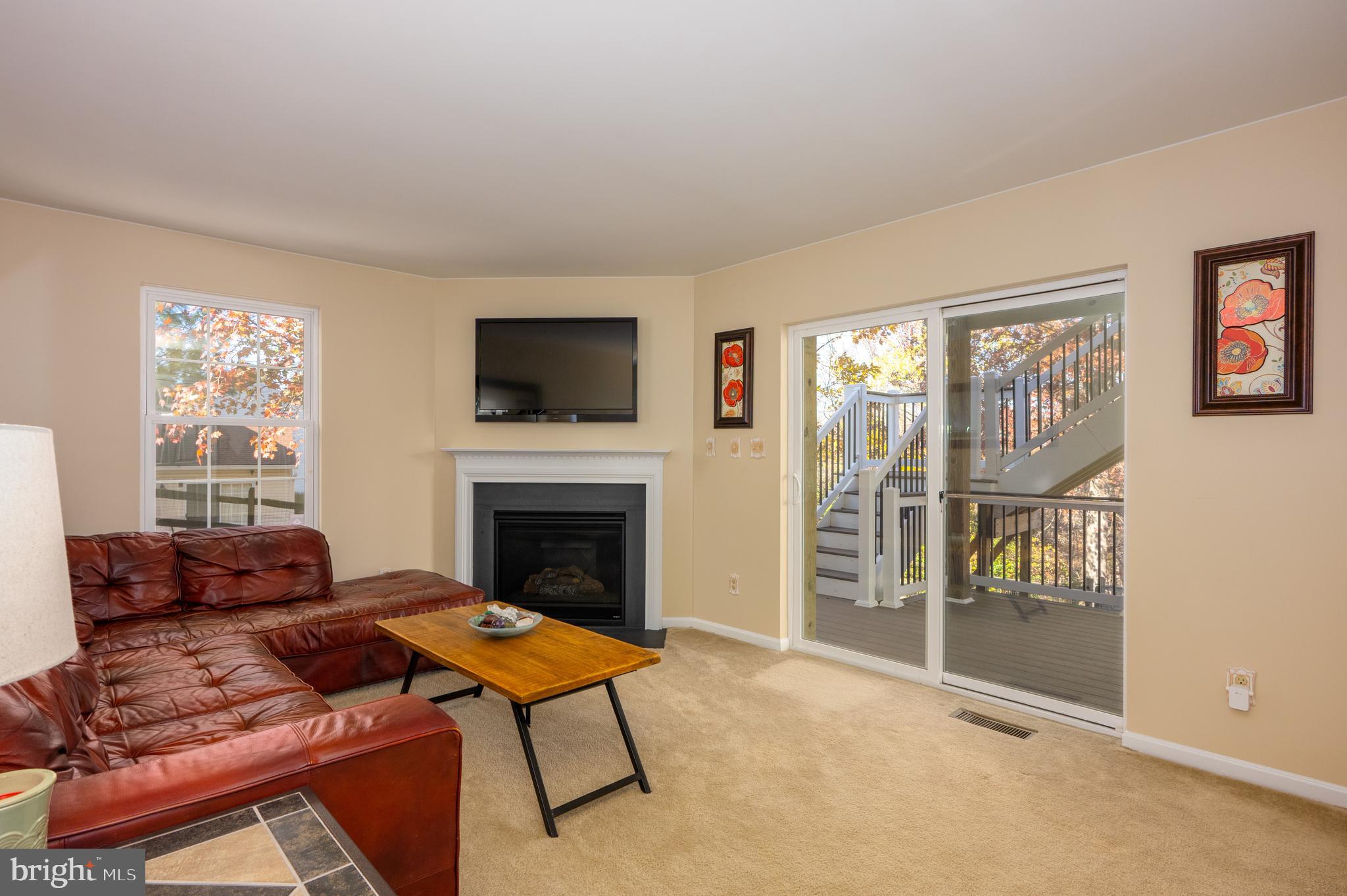 2308 Quilting Bee Road Catonsville, MD 21228 - Photo 23 of 37 a living room with furniture a flat screen tv and a fireplace