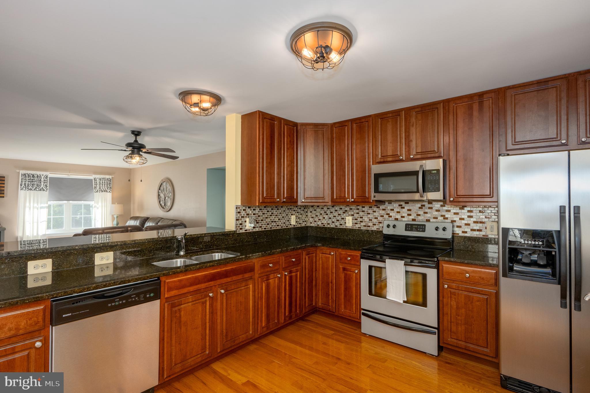 2308 Quilting Bee Road Catonsville, MD 21228 - Photo 3 of 37 a kitchen with stainless steel appliances granite countertop a stove and a sink