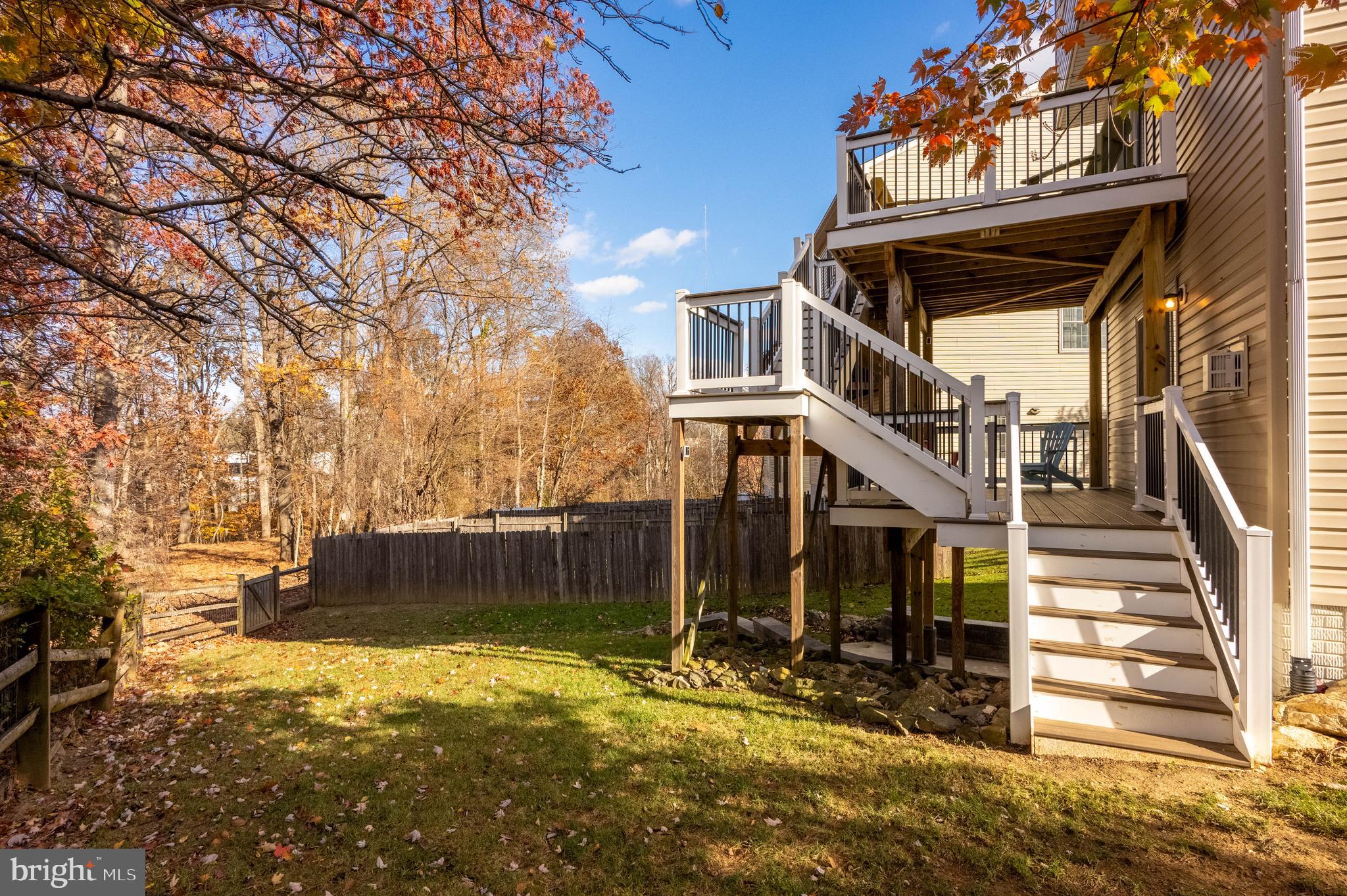 2308 Quilting Bee Road Catonsville, MD 21228 - Photo 31 of 37 a view of a house with wooden fence and a large tree