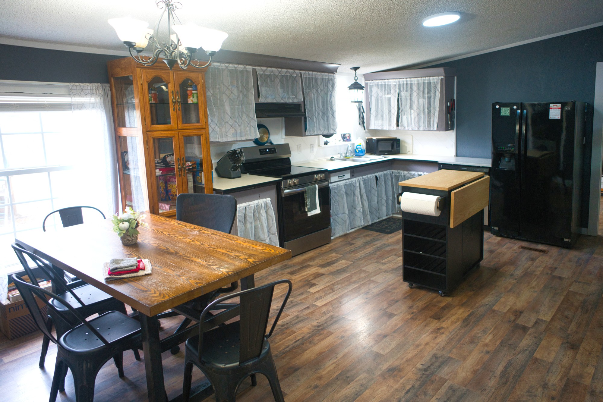3079 Trace Creek Road White Bluff, TN 37187 - Photo 17 of 35 a kitchen with granite countertop a table chairs a sink dishwasher refrigerator and cabinets