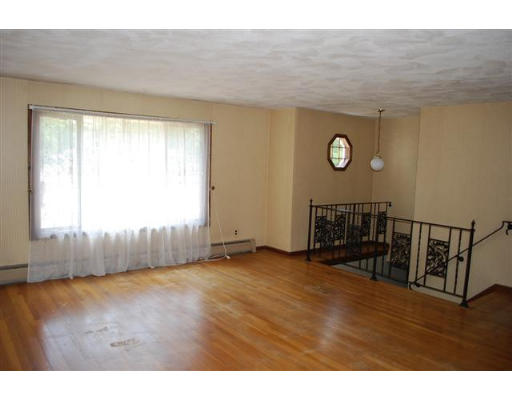 11 Handel Road Billerica, MA 01821 - Photo 4 of 16 a view of an empty room with wooden floor and a window