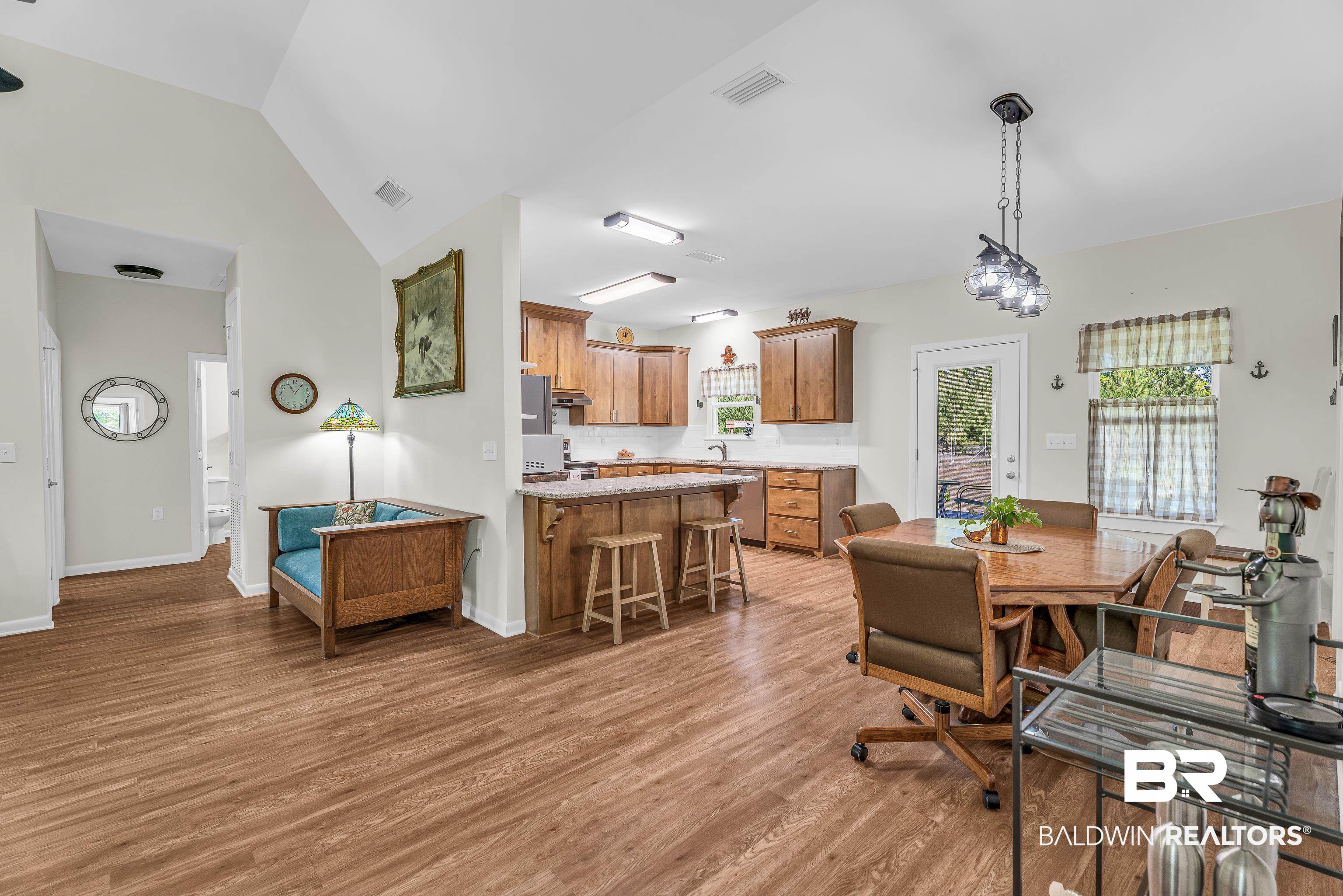 18255 Cactus Court Elberta, AL 36530 - Photo 14 of 53 Dining space featuring lofted ceiling and light wood-style flooring