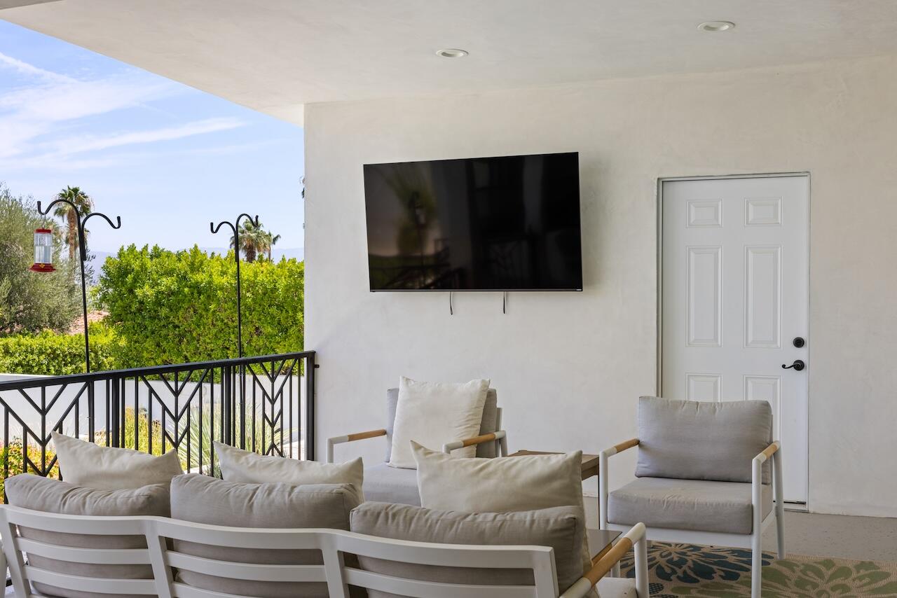 72870 Bel Air Road, Unit 4 Palm Desert, CA 92260 - Photo 21 of 35 a living room with furniture tv and outdoor view